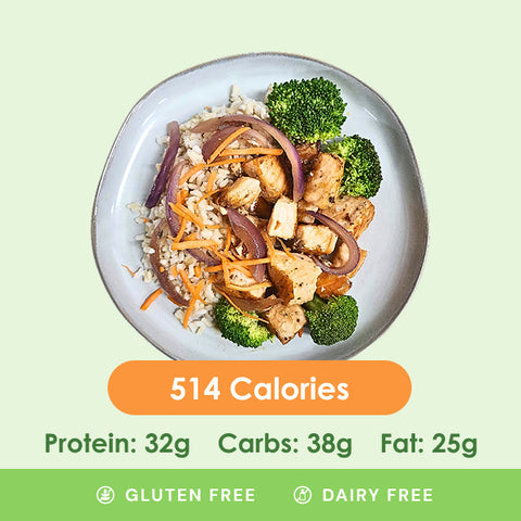 A colorful salmon stir-fry featuring tender salmon pieces, crisp broccoli florets, and thinly sliced red onions and carrots over a bed of rice.