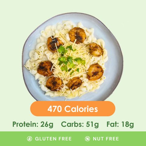 Creamy shrimp alfredo pasta, generously coated in a rich white sauce, garnished with fresh herbs, and accompanied by a side of crisp broccoli.