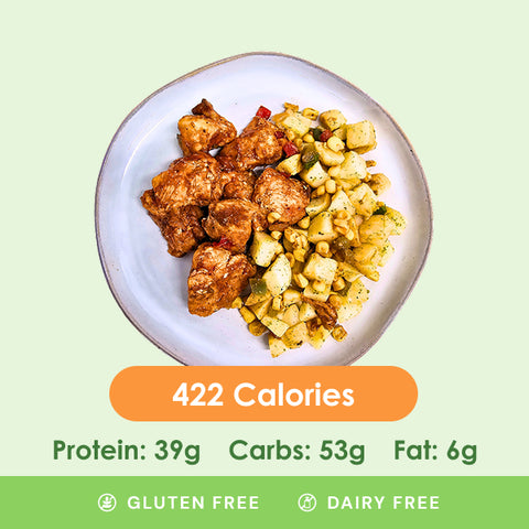 A savory smokehouse combo plate featuring tender seasoned chicken pieces and a side of flavorful diced potatoes with bell peppers.