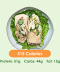 Two halves of a generously filled chicken caesar wrap, showcasing crisp lettuce and savory chicken, served on a bed of fresh greens.