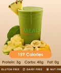 A vibrant green smoothie in a clear cup, with a pineapple slice, banana slices, and mango chunks, displaying its gluten-free, dairy-free, and nut-free status.