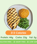 A perfectly grilled chicken breast with a savory Dijon sauce, served alongside vibrant green beans and a scoop of sweet potato mash.
