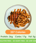 A spicy Nashville heatwave chicken dish, drizzled with a rich sauce, served with crispy sweet potato fries.