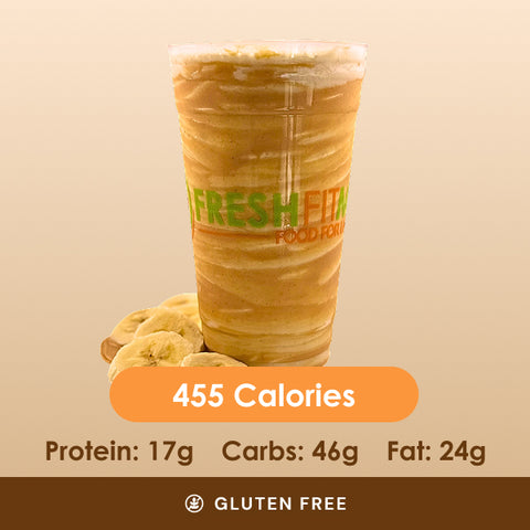 A rich peanut butter blast smoothie in a clear cup, with sliced bananas scattered around the base.