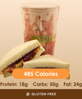 A classic peanut butter and jelly sandwich, cut in half, placed in front of a matching peanut butter and jelly swirl smoothie.