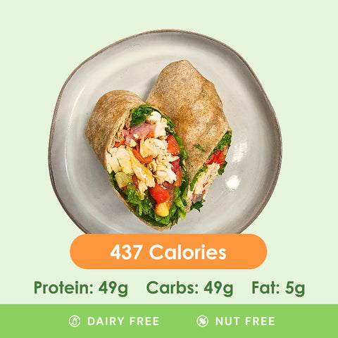 A delicious teriyaki chicken wrap, cut in half to show the juicy chicken and crisp vegetables, neatly wrapped in a soft tortilla.